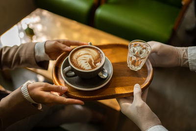 Midsection of woman holding coffee cup