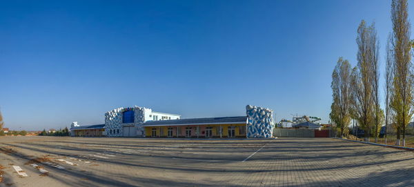 Cars on road against clear blue sky