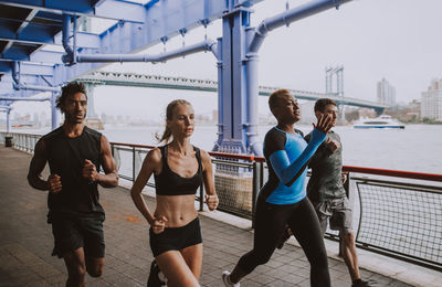 People running on road in city