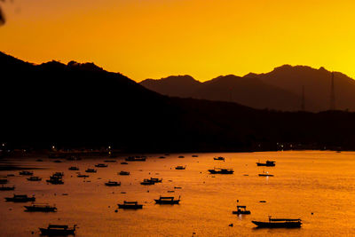 Scenic view of sea against orange sky