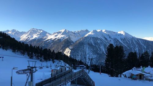 Scenic view of snowcapped mountains against clear sky