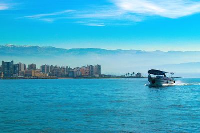 Scenic view of sea and buildings against sky