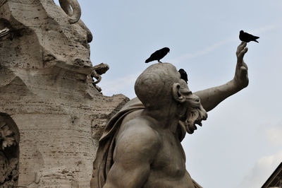 Low angle view of statue against sky