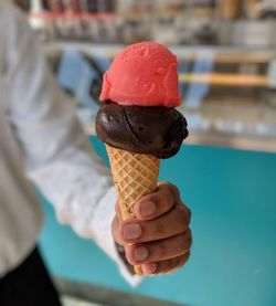 Close-up of hand holding ice cream cone