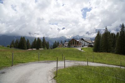 Scenic view of landscape and houses against sky