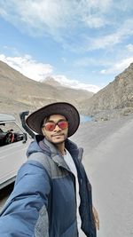 Portrait of man standing on road