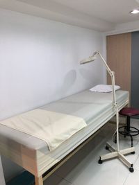 Empty bed in hospital ward