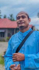 Portrait of young man standing outdoors