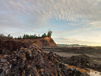 Rock formations on landscape against sky