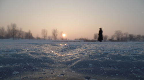 Scenic view of frozen lake against clear sky during winter