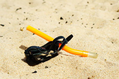 Close-up of sunglasses on sand at beach