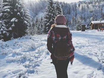 Rear view of woman on snow covered land