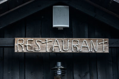 Low angle view of text on old wall