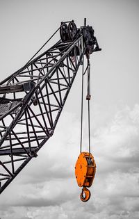 Low angle view of crane against sky