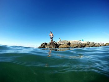 Scenic view of calm sea against blue sky