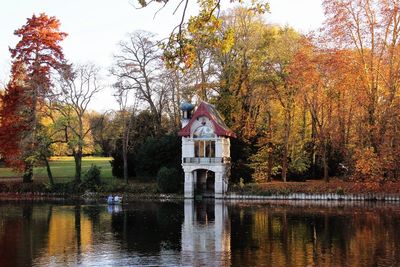 Reflection of trees in lake against sky in park during autumn