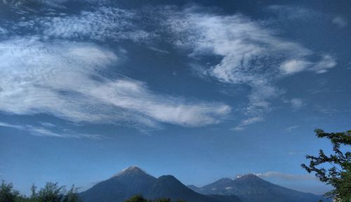 Low angle view of mountains against blue sky