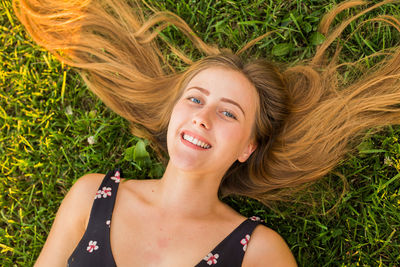 Portrait of a smiling young woman lying down