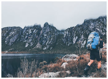 Rear view of man standing in lake