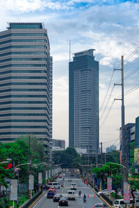 View of city street and buildings against sky