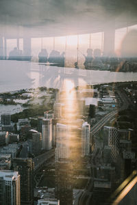 Digital composite image of modern buildings against sky