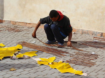 High angle view of man working on footpath