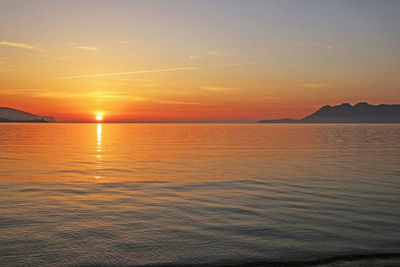 Scenic view of sea against romantic sky at sunset