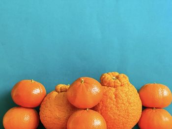 Close-up of oranges against blue background