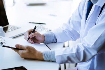 Midsection of person working on table