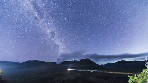 Scenic view of mountains against sky at night