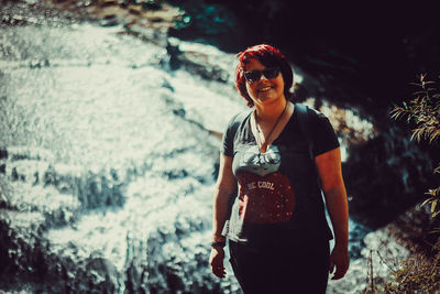 Woman wearing sunglasses standing outdoors