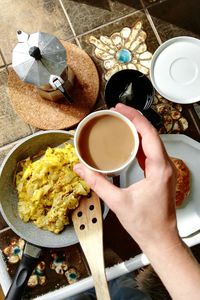 Cropped image of woman preparing breakfast with coffee at home