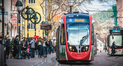 Vehicles on road against buildings in city