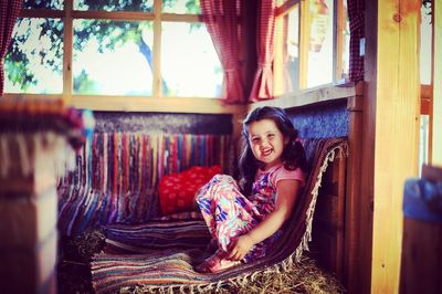 Portrait of smiling young woman sitting outdoors