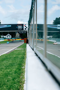 Road leading towards built structure against sky