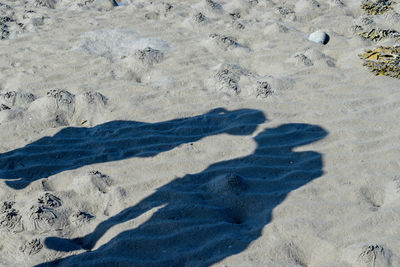 High angle view of shadows on sand