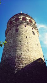 Low angle view of tower against blue sky