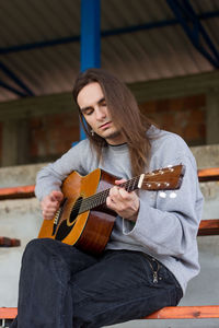 Young woman playing guitar