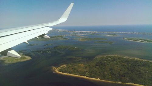 Cropped image of airplane flying over landscape