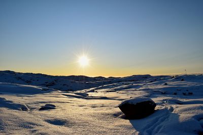 Scenic view of mountains against clear sky during sunset