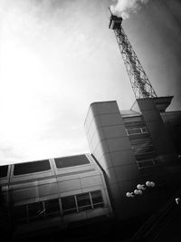 Low angle view of crane against sky