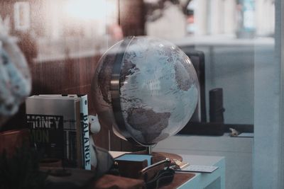 Close-up of globe on table in office