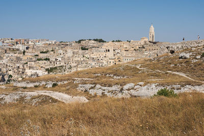 Buildings in city against clear sky