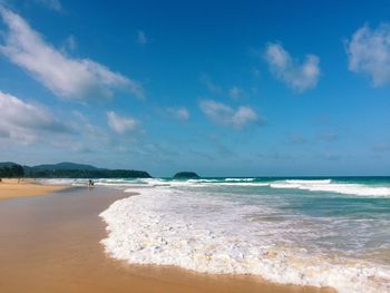 Scenic view of beach against blue sky