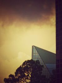 Low angle view of buildings against sky at sunset