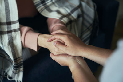 Midsection of couple holding hands