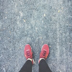 Low section of man standing on road