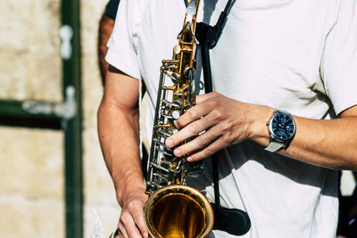 Midsection of man playing guitar