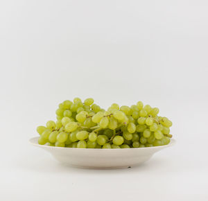 Close-up of fruits in bowl against white background