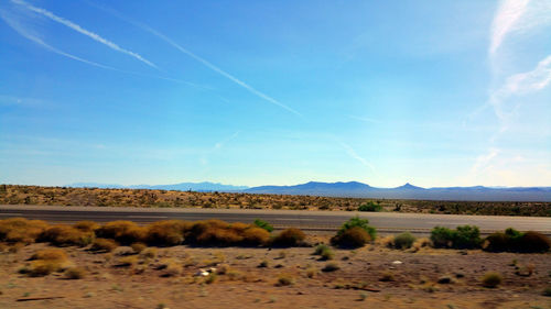 Scenic view of field against blue sky